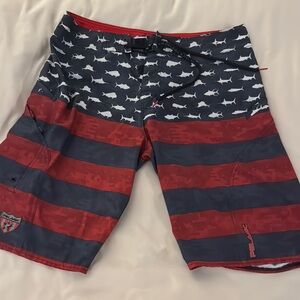 Pelagic Red and Blue Board Shorts with Shark Pattern